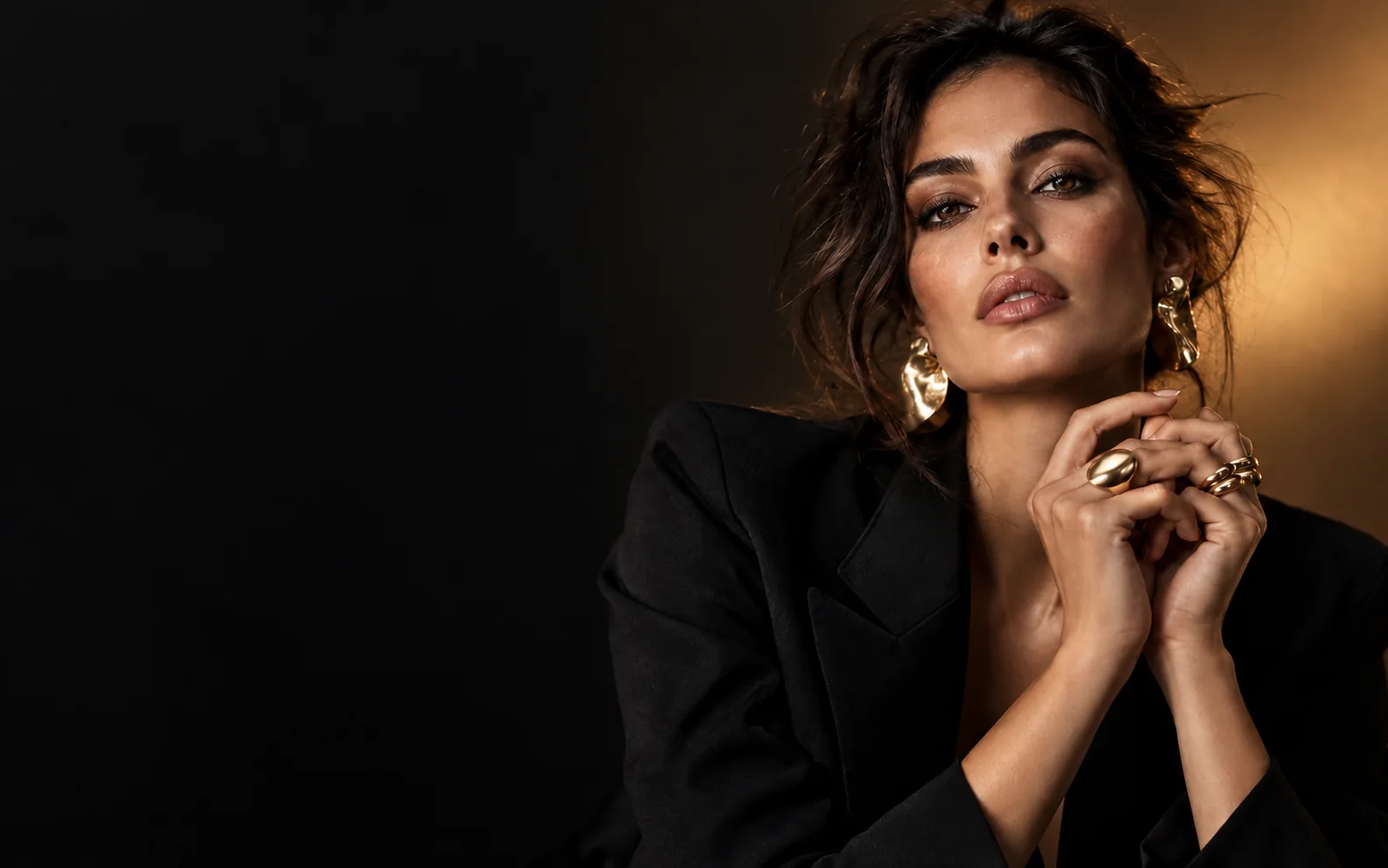 Fashion jewelry editorial concept in a warm gold studio